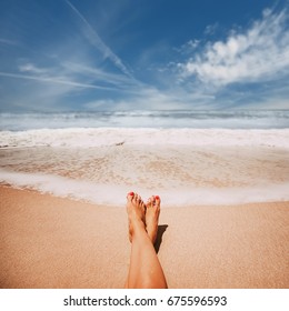 Female feet on sandy ocean  beach. picture with soft focus and place for your text. summer concept