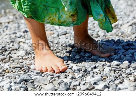 Female feet on the seashore