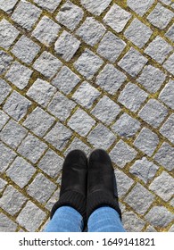 Female Feet On Stone Pavers, Top View.