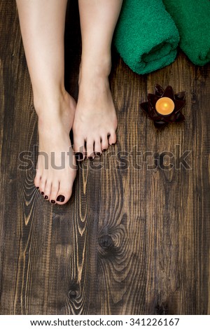 female feet with painted nails at the spa