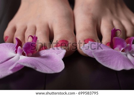 Female feet red pedicure nails