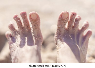 Female Feet With Spread Toes On The Beach