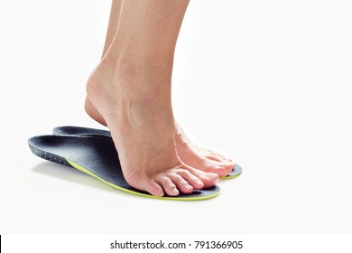 female feet stand on their toes in orthopedic insoles