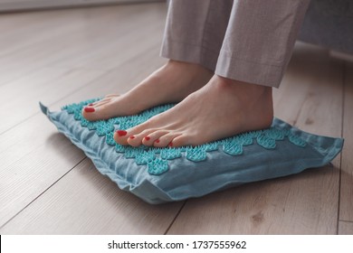 Female Feet Standing On Acupressure Mat. Self Acupuncture Massage. Woman Having Alternative Medicine Treatment.