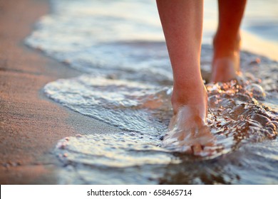 Female feet step on the sea wave. Summer vacations concept - Powered by Shutterstock