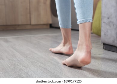 Female feet walking on floor at home.