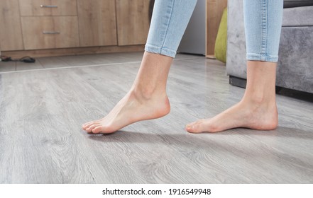 Female Feet Walking On Floor At Home.