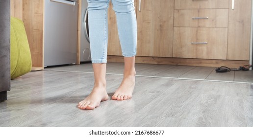 Female Feet Walking On Floor At Home.