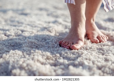 female feet walking on salt deposits