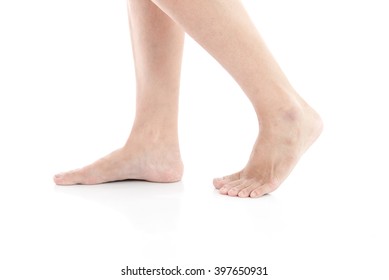 Female feet walking on white background isolated