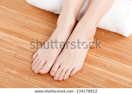 female feet with a white rolled towel