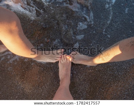 Female feets on the sand at the beach