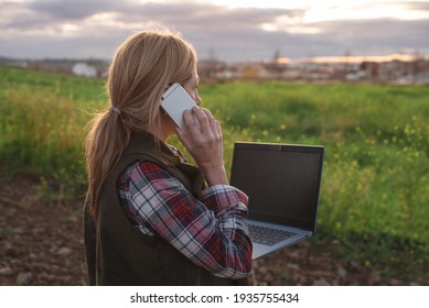 Female field engineer with a laptop computer examining agricultural plantation. Integration of women in the field, smart agriculture and happy women concepts - Powered by Shutterstock