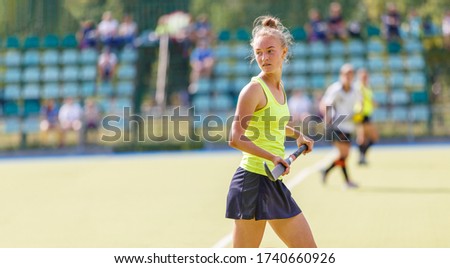 Female field hockey player in the game.