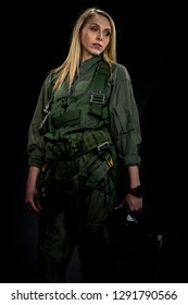 A Female Fighter Pilot Poses Against A Black Background In A Studio Environment 