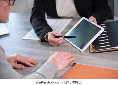 Female Financial Adviser Giving Information On Digital Tablet To Her Client