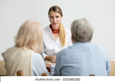 Female Financial Advisor Consulting Senior Couple About Making Investment, Insurance Broker, Realtor Or Travel Agent Talking To Older Family Presenting New Offer At Meeting, Woman At Job Interview