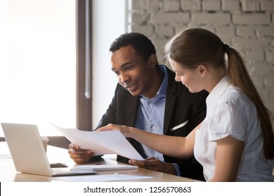 Female financial advisor insurer banker consulting male african american client about contract, caucasian mentor hr and black intern new employee discussing documents at meeting advice