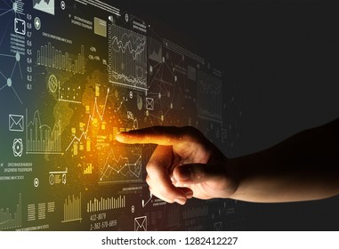 Female finger touching a beam of light surrounded by charts and graphs