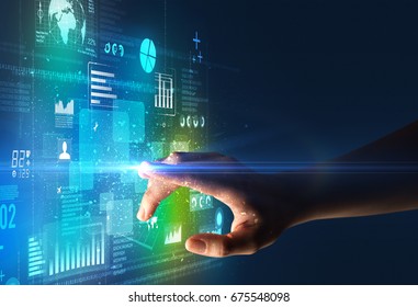 Female Finger Touching A Beam Of Light Surrounded By Blue And Green Data And Charts