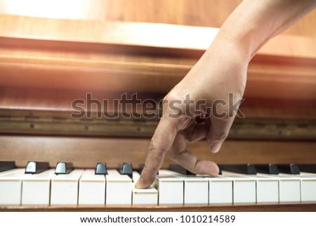 Female fingers walking on the piano.