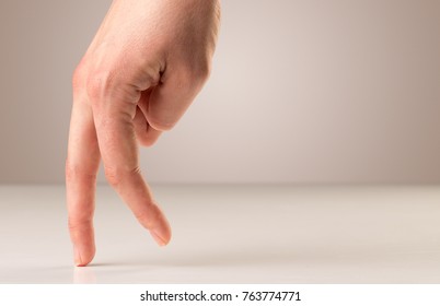 Female fingers walking on white surface