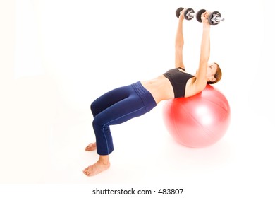 A Female Fitness Instructor Demonstrates The Finishing Position Of The Dumbell Press On A Fitball