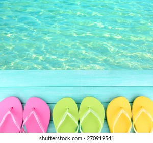 Female Flip Flops On Wooden Platform Beside Sea