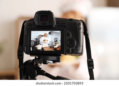 Female food blogger with tasty pasta recording video on camera screen in kitchen, closeup - Powered by Shutterstock