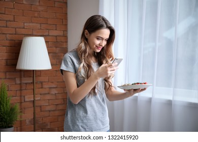 Female Food Photographer With Mobile Phone Taking Picture Of Tasty Breakfast At Home