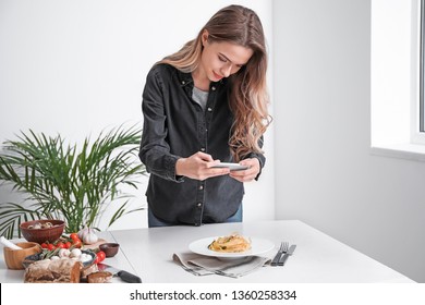 Female Food Photographer With Mobile Phone Taking Picture Of Tasty Food At Home