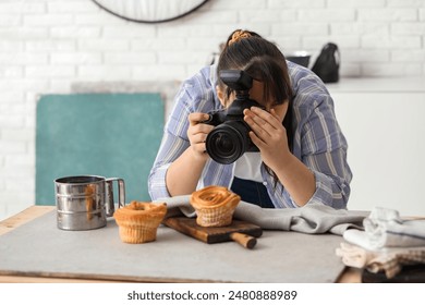 Female food photographer taking picture of tasty cakes in studio - Powered by Shutterstock