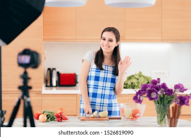 Female Food Vlogger Filming A Cooking Video In Her Kitchen. Woman Behind The Scenes On A Cooking Live Streaming Show
