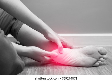 Female foot heel pain with red spot, plantar fasciitis