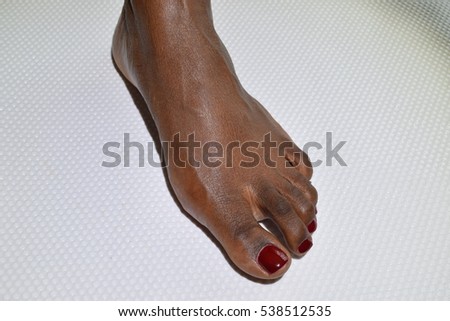 Female foot pedicured side view on a white background