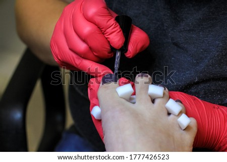 Female foot in process of professional pedicure in a beauty salon, close up. Beauty, health, fashion concept.