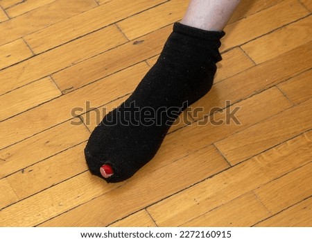 Female foot in ripped sock with big toe sticking out