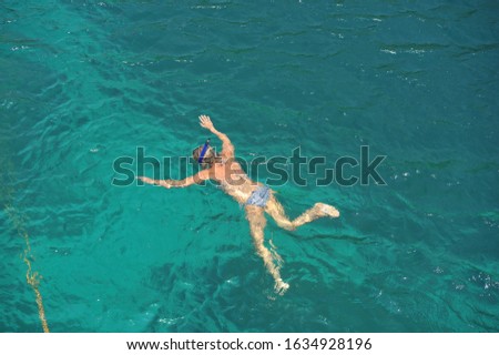 A female foreign tourist enjoy snorkeling in Samui Island, Thailand.