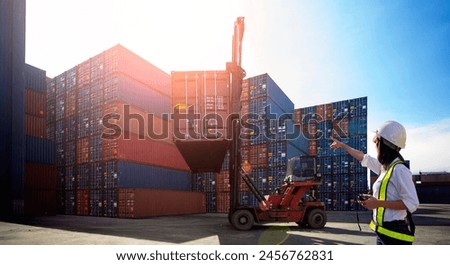 Female foreman control loading Containers box from Cargo freight ship for import export  