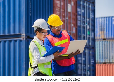 Female foreman safety vest using clipboard checklist and Worker man in hardhat holding laptop for control loading containers box from cargo