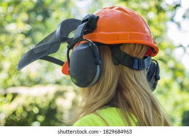 Female Forester Worker With Protective Helmet In Forest