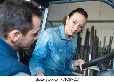 Female Fork Lift Truck Driver Working In Factory