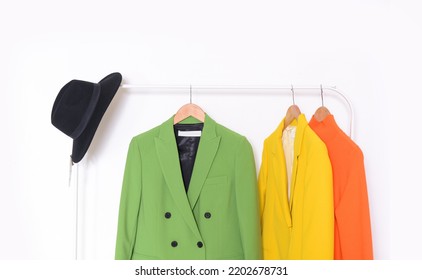 Female, Formal Green With Yellow, Suit, Jacket With Orange Dress On Hanger –white Background