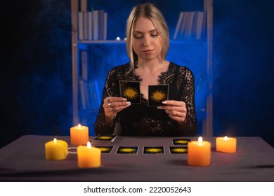 Female fortune teller read tarot cards to predict fortune. Future reading. Ritual candles burning, seance