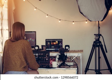 Female freelance editor working editing video footage with laptop in house studio this is lifestyle of blogger or content creator freelance