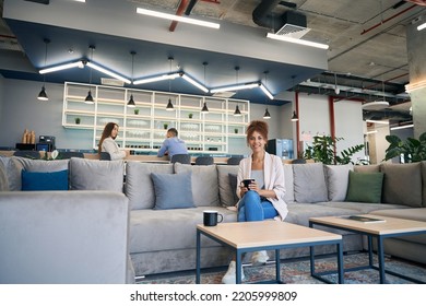 Female freelancer enjoying her rest break in co-working space - Powered by Shutterstock