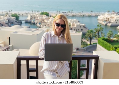 A Female Freelancer While Working On A Laptop. Work During The Summer Holidays