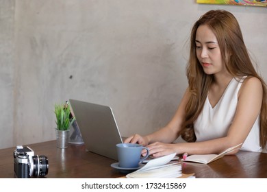 female freelancer working on her project with laptop and office supplies - Shutterstock ID 1732415869