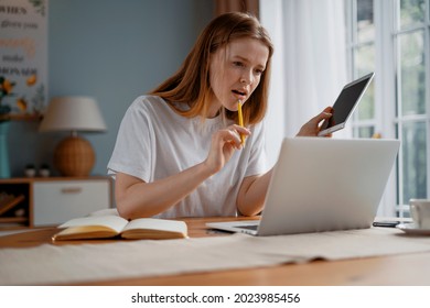 A female freelancer works at home on an online laptop. A student communicates with friends on a social network. - Shutterstock ID 2023985456