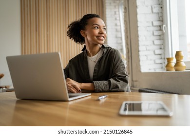 A female freelancer works in an office coworking space, uses a laptop computer - Shutterstock ID 2150126845